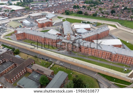 Aerial drone footage of the town centre of Wakefield in West Yorkshire in the UK showing the main building and walls of Her Majesty's Prison Royalty-Free Stock Photo #1986010877