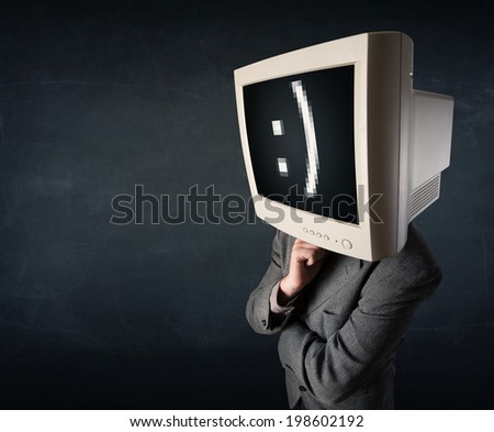 Funny young businessman with a monitor on his head and smiley on the black screen