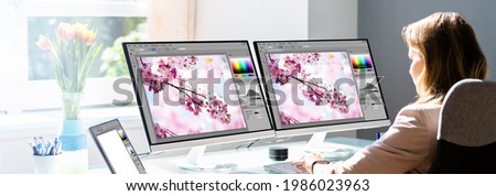 Woman Working On Computer Monitors Making Graphic Web Design