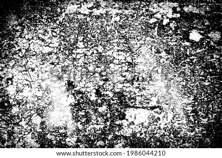 The grunge texture is black and white. Monochrome abstract background. Pattern of scratches, chips, and paint strokes. Black smudges, scuffing, wear and tear
