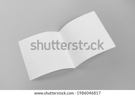 Blank paper brochure on light grey background. Mockup for design