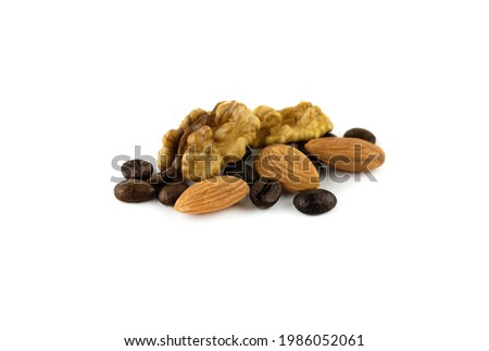 walnuts with a scattering of coffee beans and almonds isolated on a white background close up