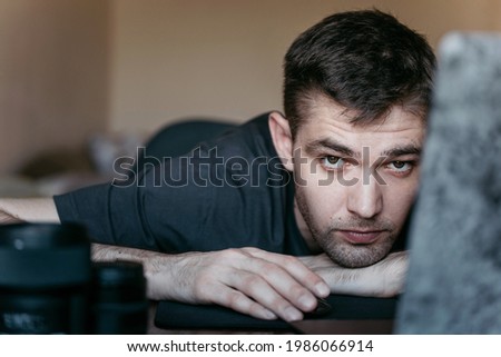 portrait of the guy behind the laptop, working in the workplace.