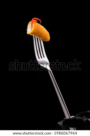 Breaded Fried chicken drum and flat on a fork with copy area
