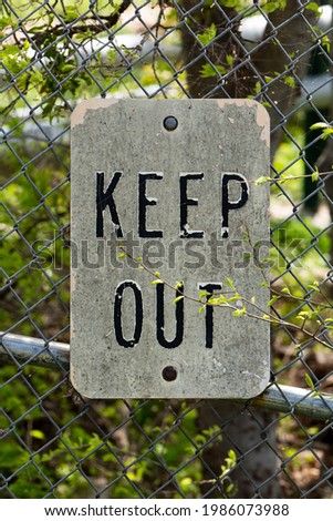 Old Forgotten Keep Out Sign on a Fence