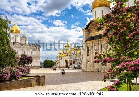 Inside Moscow Kremlin, Russia. Nice panorama of Dormition, Archangel and Annunciation cathedrals, old Russian churches in Moscow city center. Theme of bloom, landmarks and travel in summer Moscow. Royalty-Free Stock Photo #1986101942