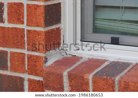 Worn out caulking around the window pane. Dried off caulking that needs to be replaced. Royalty-Free Stock Photo #1986180653