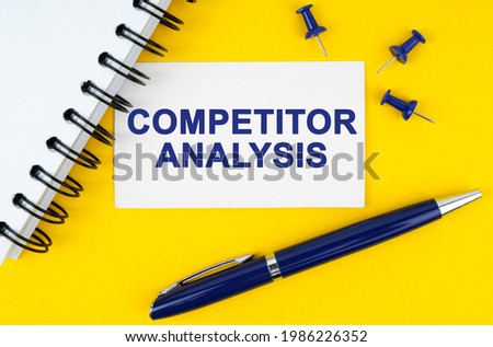 Business and finance concept. On a yellow background lies a notebook, a pen and a business card with the inscription - COMPETITOR ANALYSIS