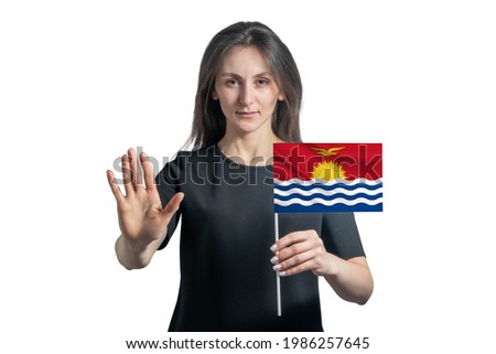 Happy young white woman holding flag of Kiribati and with a serious face shows a hand stop sign isolated on a white background.