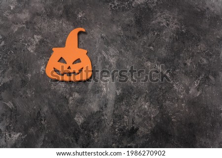 Scary smiling Halloween pumpkin head shaped sticker on grey background. Happy Halloween holiday card, copy space.