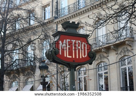 A classic metropolitan entrance signage in Paris stand beautifully in front of european classic building