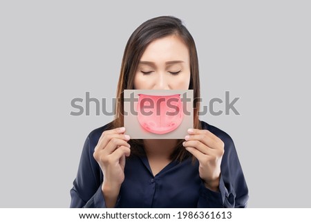 The woman show the picture of tongue problems, Illustration benign migratory glossitis on a brown paper, Behcet's Disease Royalty-Free Stock Photo #1986361613