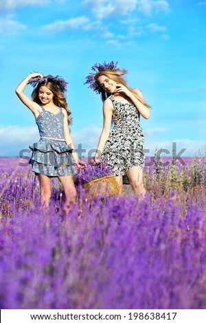 Two girls in wreaths on the lavender field