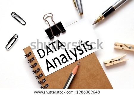 data analysis. the inscription on the business card is attached to the notebook.