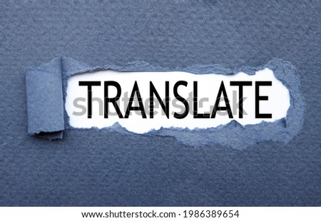 Translate. text on torn cardboard. black letters on white paper