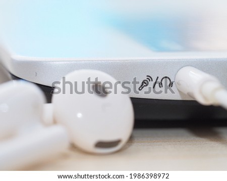 Plugging in the earphone into the laptop in closeup view