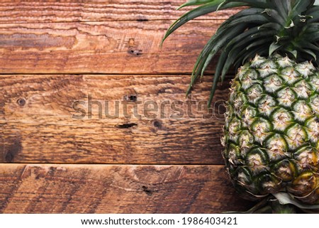 Pineapples on a brown wooden table in Thailand.