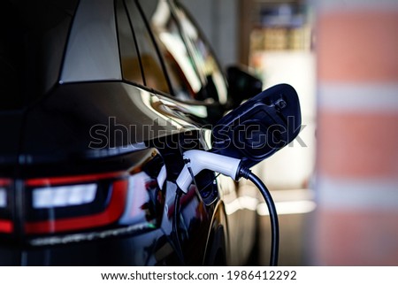 Convenient charging at home a wallbox for electric car makes it possible. Wallbox is the safest, fastest and most convenient charging option at home, a charging station with high performance decide Royalty-Free Stock Photo #1986412292