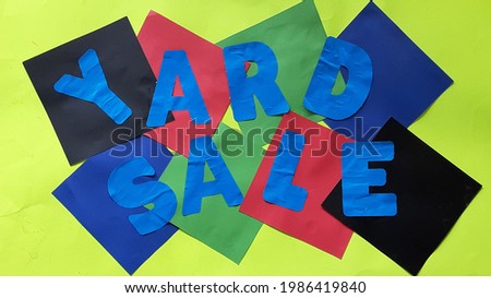 Colorful yard sale sign with blue letters