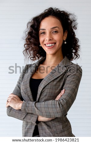 Portrait beautiful powerful and successful african businesswoman with curly hairstyle wearing formal suit, standing and crossing arms with confident and profession, Presenting woman leader, diversity