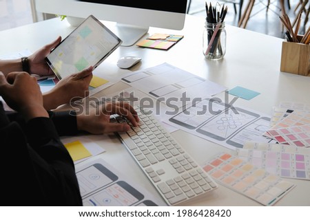 Web designer planning application for mobile phone. Design application development draft sketch drawing online Technology Content.User experience concept.
