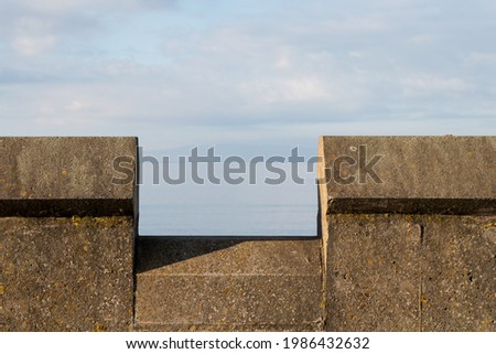 Parapet wall at a coastal beach location Royalty-Free Stock Photo #1986432632