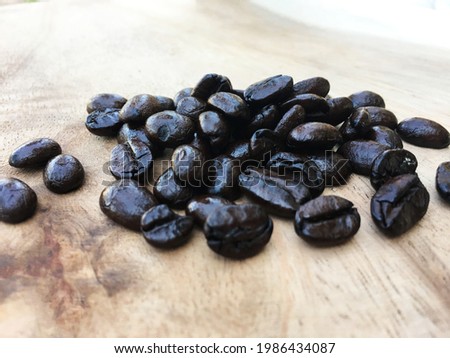 Coffee beans on grunge wooden background.