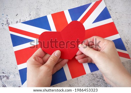 I love England. Red papaer heart on United Kingdom flag background. 7 june British national day, closeup