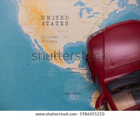 A map of Mexico and a red car.