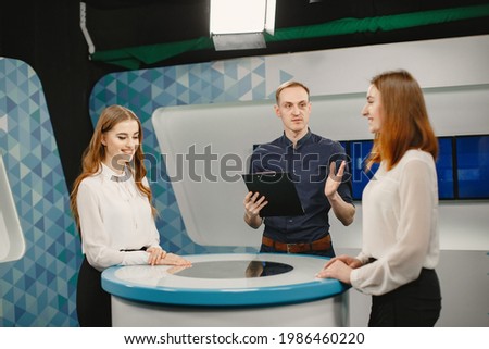 Tv host and two participants on game show Royalty-Free Stock Photo #1986460220