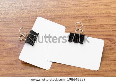 card and clip design on wood background