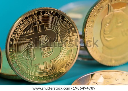 Close up Golden bitcoin BTC Dogecoin DOGE group included with Cryptocurrency Ethereum ETH, Stellar XLM symbol Virtual blockchain technology future is money concept and Macro photography.