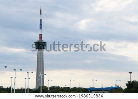 Remote photo Lighthouse and traffic control tower sailing as national flag picture with clouds a background a symbol of the port of Lamchabang , Thailand