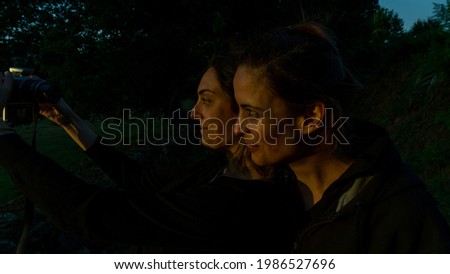 selfie of two women in the horizontal light of sunset