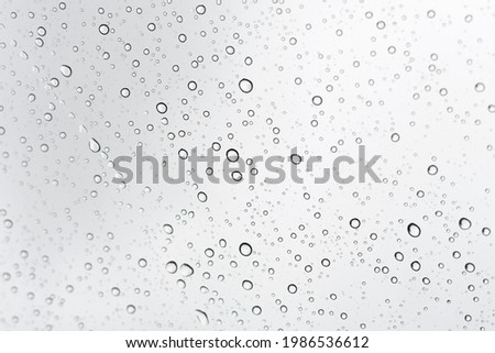 Raindrops on a transparent surface. Transparent drops of water on glass.