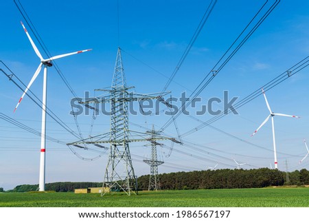 Wind turbines , power poles with power lines Royalty-Free Stock Photo #1986567197