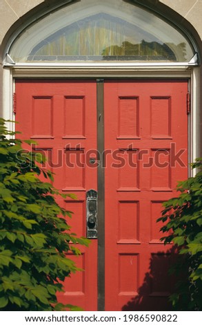 Picture of a red door among green plants