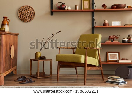 Stylish composition of retro living room interior with design armchair, wooden bookcase, coffee table, picture frames, plant, carpet, slippers, decoration , elegant accessories in home decor. Template