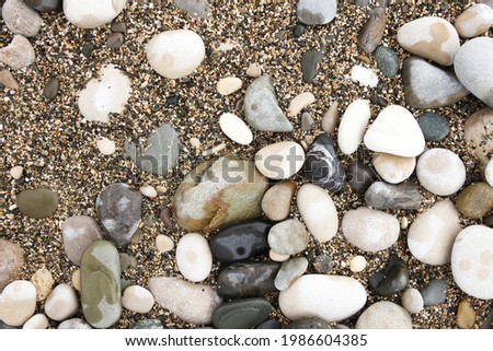 stones and pebbles with sand on the seashore as texture