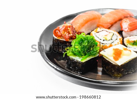 many sushi on black dish with drop shadow on white background pattern