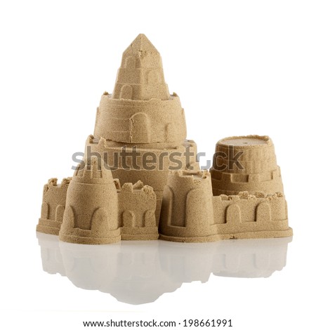Sandcastle at the beach isolated over white 