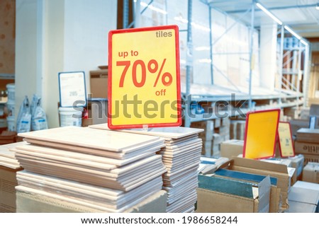 Announcement of seventy percent discounts on ceramic tiles in a finishing materials store.