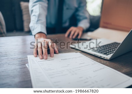 HR staff Submit a job application for new employees to fill out job application documents.job vacancy, job application concept. Royalty-Free Stock Photo #1986667820
