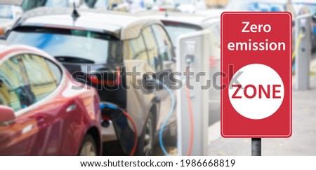 Road sign "Zero emission ZONE" on a background of electric cars. Clean mobility concept Royalty-Free Stock Photo #1986668819