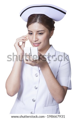 Young woman asian nurse attractive beauty brunette holding face powder for make up in white background