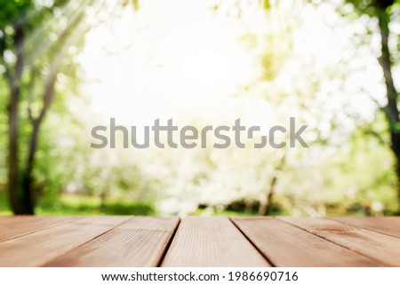 Sun rays on blurred view from wooden deck on balcony. High quality photo
