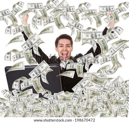 Portrait of successful young businessman with money rain