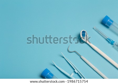 Medical instruments, devices and items on the colored table in the hospital. Syringe, test tube, tweezers. Healthcare, medicine, treatment and doctors concept
