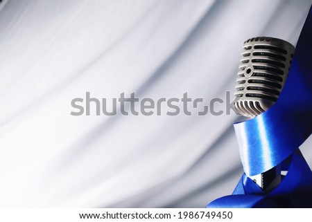 Stand with a retro microphone. Microphone on a tripod. Performance of the artist with vintage microphone. Scene with a microphone.