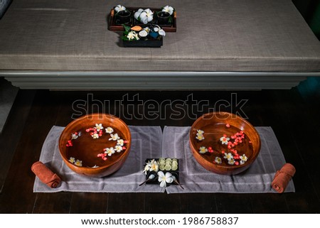 Set for Thai foot massage in the spa salon. Flowers, towels. Relaxation and enjoyment